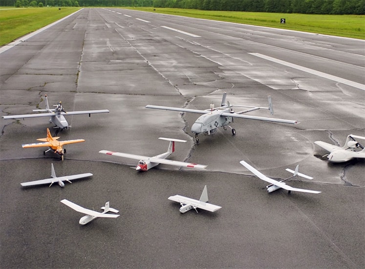 collection of small drones on a runway